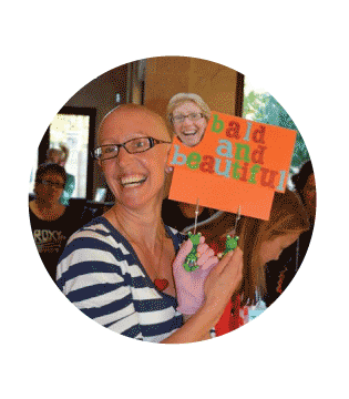 fundraiser holding a banner which says "bald and beautiful"