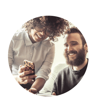 Two people viewing the JustGiving website on a phone.